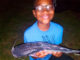 A young angler shows off a tagged catfish during the 2021 Tagged Catfish Derby.