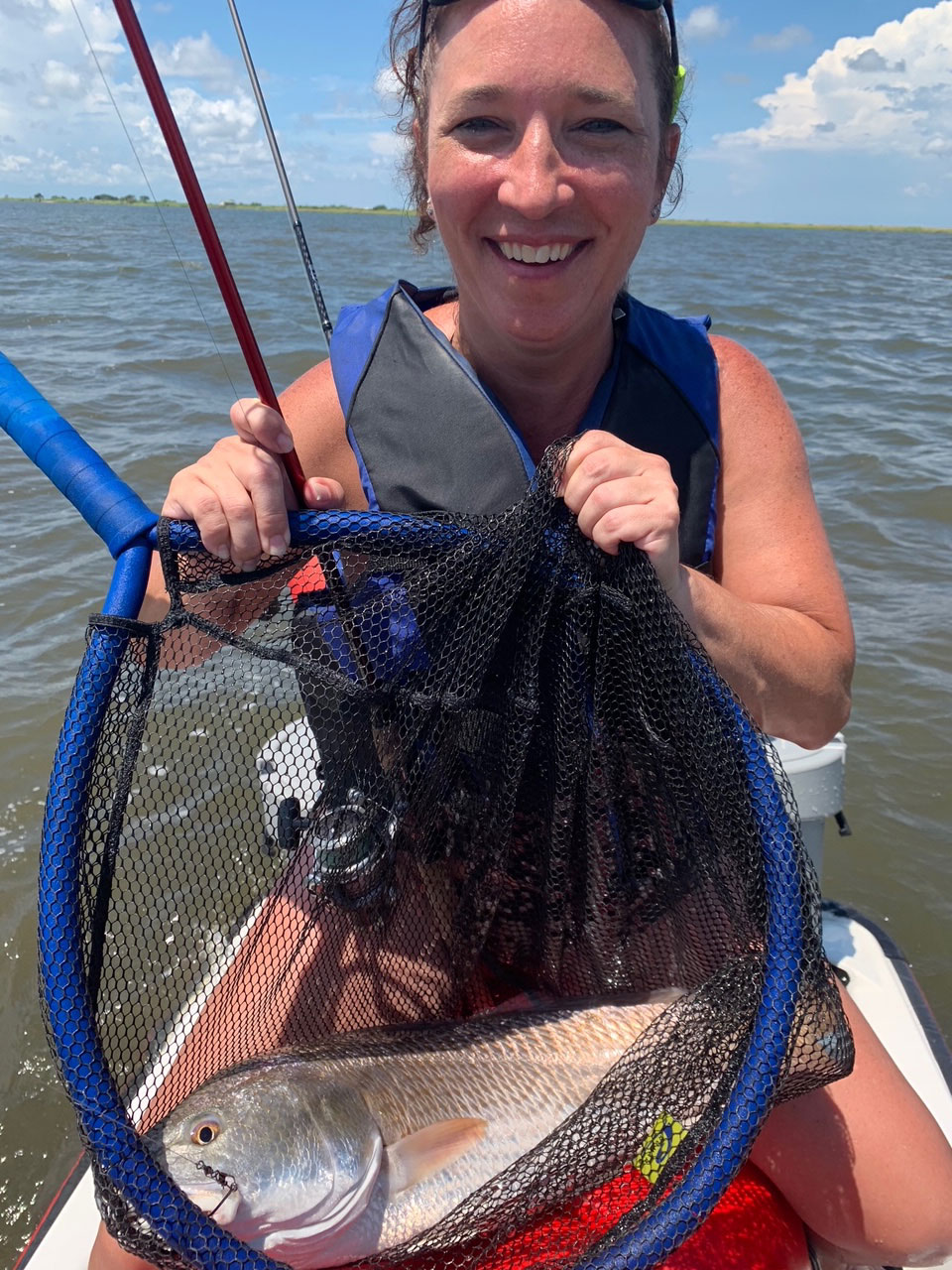 Gena Randall shows off the 30-inch red that she caught near the Rigolets. It's her personal best. 