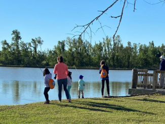 A family fishing together at the Bayou Country Sports Complex in Houma after it was recently stocked with adult-sized channel catfish.