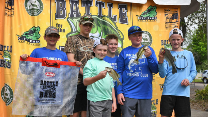 These youngsters, shown with their catch of bass, are among thousands who have enjoyed this annual event over the years.