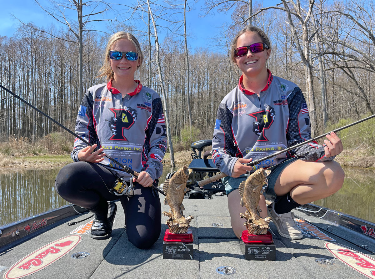 Taylor Bacot, left, and Alexis Virgillito holds the Dobyns spinning rods that helped them capture The Bass Federation High School State Championship at Caddo Lake.
