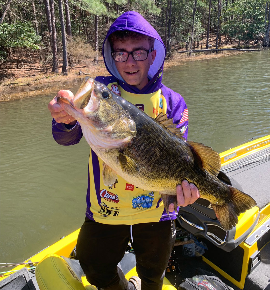 Ross Kliebert caught this huge 12.45-pound Caney lunker. His fishing partner Zane Zeringue lipped the bass and got him in the boat for the team.