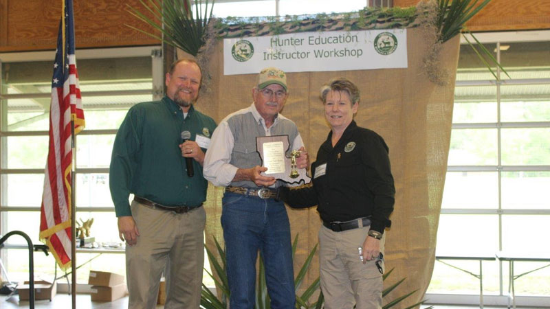 Joe Henderson (middle) accepts an Outstanding Volunteer award on behalf of the Jena Junior High teaching team from LDWF's Eric Shanks (left) and Dana Norsworthy. (Photo courtesy LDWF)