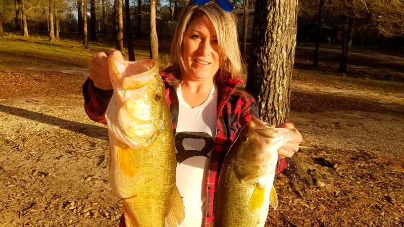 Rene Guidry with the 9-pound 6-ounce bass and 5-pound bass she caught in March 2022.