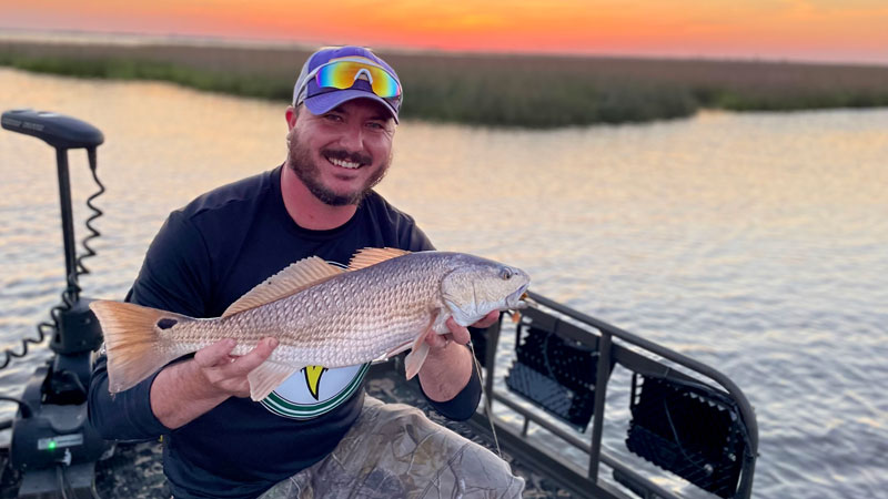 Scott Gibson of Slidell with a redfish caught on an orange plastic crawfish rigged on a weedless hook with spinner.