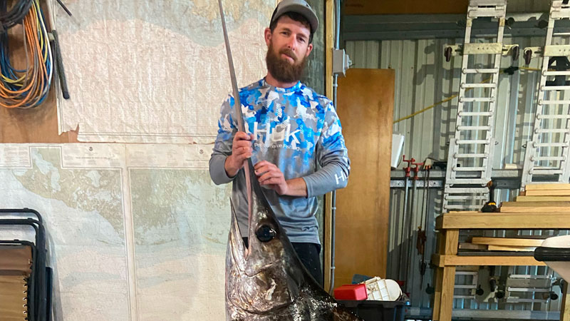 Alex Sevin with a 177-pound swordfish he helped get for clients that chartered a trip 100 miles out of Cocodrie.