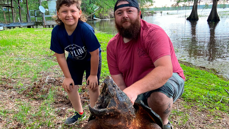 Reed Powell, 7, and Josh Powell, 35, caught this alligator snapping turtle on Lake Bistineau in Doyline April 30, 2022.