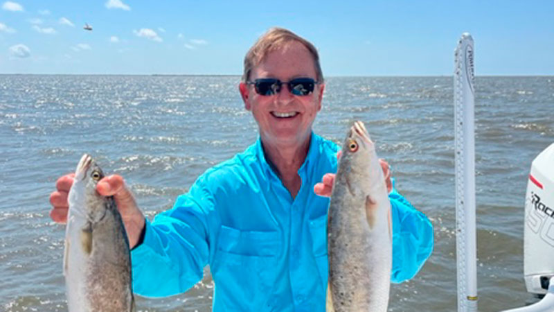 Steve Ashy of Doug Ashy Building Materials with two “sow” trout “ from the beach off Grand Isle on May 5, 2022.