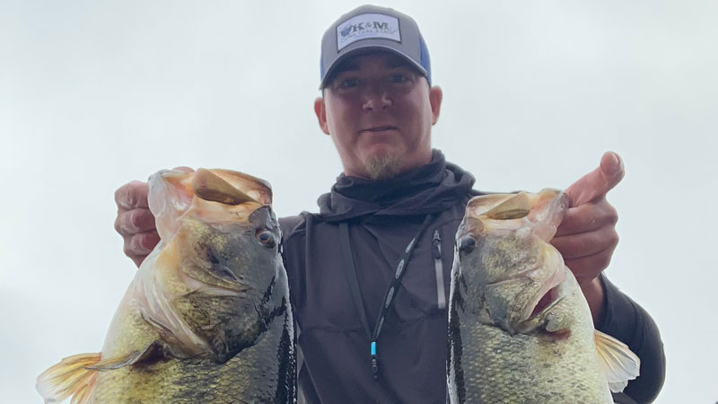 Heath Kennedy with a 10.3-pound bass and a 6-pound bass caught directly on the tail end of a bad storm on March 23, 2022 at Caney Lake in Chatham.