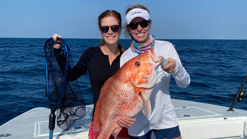 Allison Talley and Mallory OBrien Talley with a huge red snapper caught out of Fourchon.