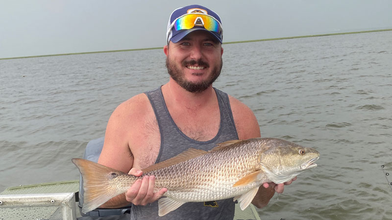 After getting caught in a summer rain shower on an evening fishing trip in the Rigolets marsh/Little Lake, Scott Gibson of Slidell landed the biggest bull red of his life.