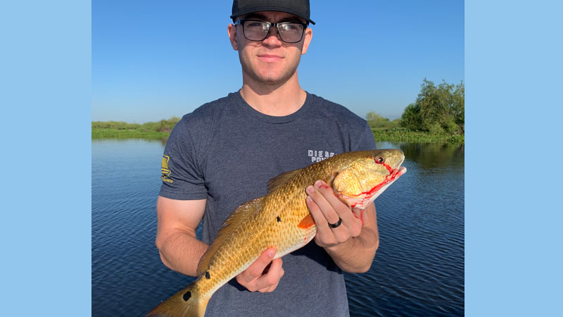 Cpl. (USMC) Keith Bender caught his first redfish in Chauvin fishing with his dad Tim.