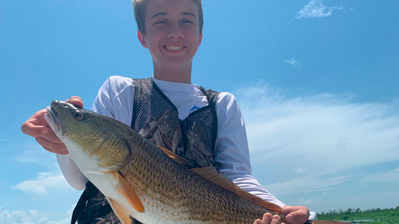 John Dillworth with the 25-inch redfish he caught during his birthday trip on July 16, 2022.