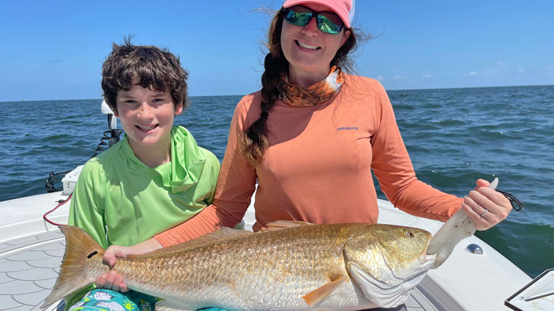 Nicole Morello and her son Jake with one of the beautiful bull reds she caught around rigs in the Ship Shoal area south of Terrebonne Parish in June.