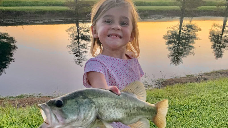 Charlie Mac Francois, 4, with a bass caught in a private pond in August on a live worm.