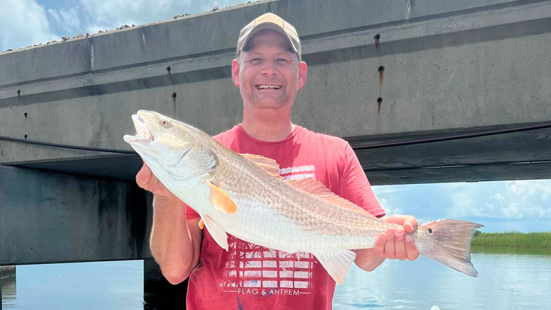 Brandon Fischer with a 32-inch redfish caught in Unknown Pass on 12-pound test. His first bull red in 15 years since moving to Texas.
