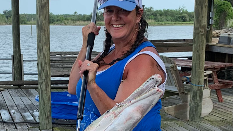 Sherie Lute of Central Arkansas landed a 4 foot gar off the dock in Moss Lake on Aug. 30, 2022 . It was her first trip to Southwest Louisiana.