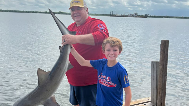 Slade Dowden and his Paw Paw Andy Martarona show off Slade's 46-inch long shark that was released afterwards.