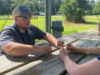 LDWF Biologist, Chris Conner, teaches participant a fishing knot during an Intro to Fishing Course. (Photo courtesy LDWF)