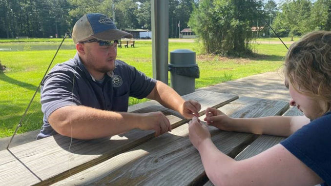 LDWF Biologist, Chris Conner, teaches participant a fishing knot during an Intro to Fishing Course. (Photo courtesy LDWF)