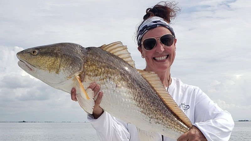 The queen of the horseshoe at Hopedale Marina, Tammy Bretey with the bull red she caught and released at Toenail Reef in Eloi.
