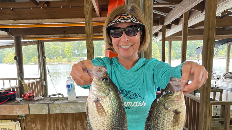 Mary Anne Smith from Lafayette displaying two of her sac-a-lait she caught at Toledo Bend.