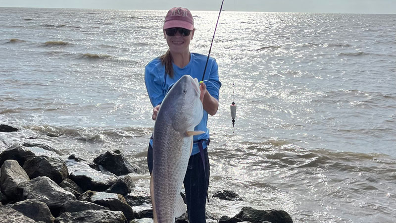 A Sunday morning started off right! Jennifer Langlinais of Mouton Cove caught this big ol' red fishing from the beach of Cheniere Au Tigre.
