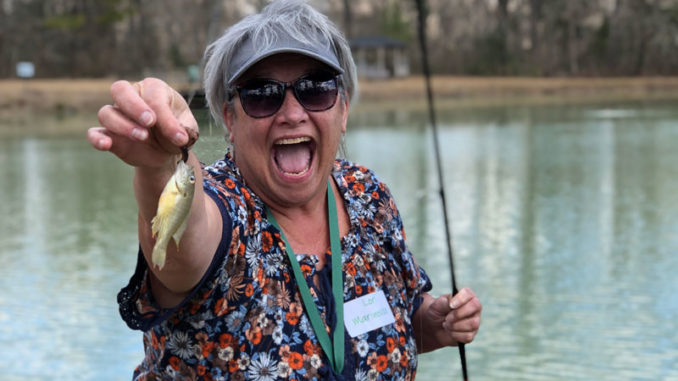 Participant Lori Marinovich poses with her catch from fishing practice during a Women’s Fishing 101 Workshop. (Photo courtesy LDWF)