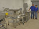Thomas Hymel and Evelyn Watts of the LSU AgCenter and Sea Grant, stand next to equipment in the Seafood Processing Demonstration Lab in Jeanerette. (Photo courtesy of LSU AgCenter)