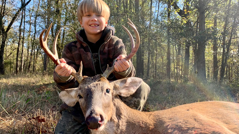 Rhett Campbell, 7, with his first buck, a 9-point, harvested in Webster Parish on private land.