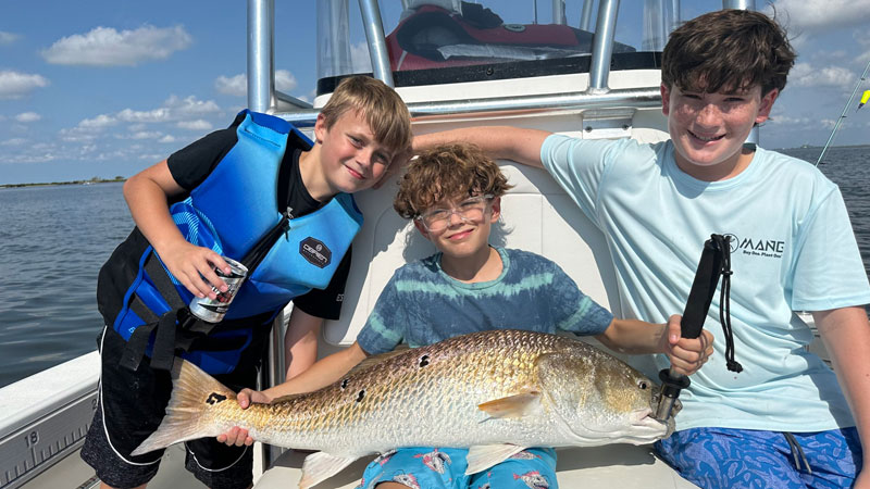 Gabe, Abram, and Jake, 6th graders at Parkview Baptist in Baton Rouge, caught, tagged, and released several 30-pound bull reds.