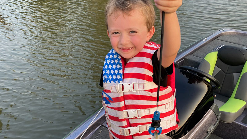 Hunter Coates, 5, holds one of the bass he caught using a Junebug red speed craw on Lake Verret.