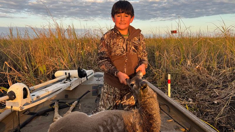 Lowen Mouret, 8, with the marsh doe he got with his .308 rifle on Nov. 26, 2025 in Area 7.