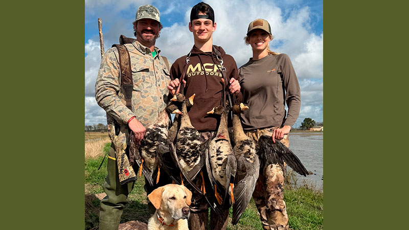 Michael Desormeaux, Thomas Desormeaux, Amanda Woodard and Lulu the dog after a successful hunt in Kaplan, La., on Dec. 26, 2025.