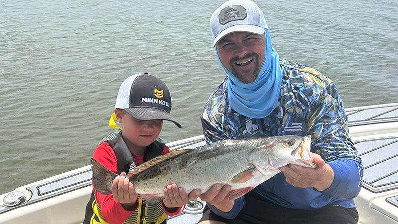 William Arceneaux and his son, Harris, with a 22-inch, 4.8-pound trout caught at the Fourchon rocks back in May 2025.
