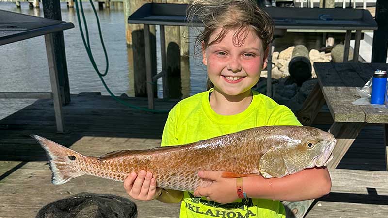 Millie Chatelain, 10, of Mansura with a big redfish she caught in Hackberry.
