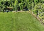 7.863 acre lot with water access to New River leading to Diversion Canal, house pad, pond, and space for your house and shop