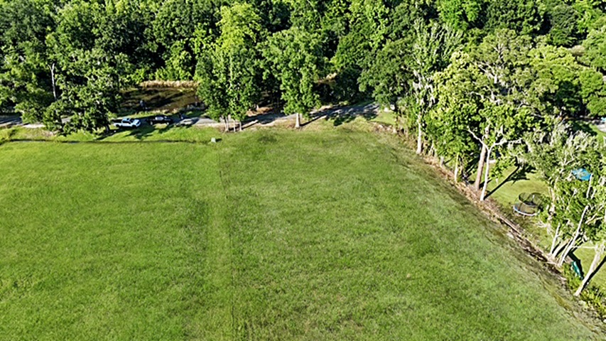 7.863 acre lot with water access to New River leading to Diversion Canal, house pad, pond, and space for your house and shop