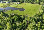 7.863 acre lot with water access to New River leading to Diversion Canal, house pad, pond, and space for your house and shop