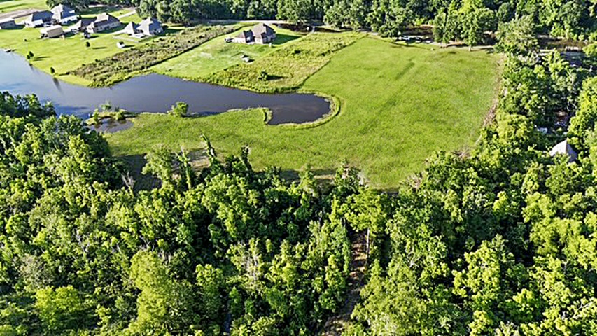 7.863 acre lot with water access to New River leading to Diversion Canal, house pad, pond, and space for your house and shop