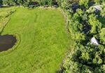 7.863 acre lot with water access to New River leading to Diversion Canal, house pad, pond, and space for your house and shop