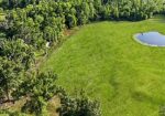 7.863 acre lot with water access to New River leading to Diversion Canal, house pad, pond, and space for your house and shop